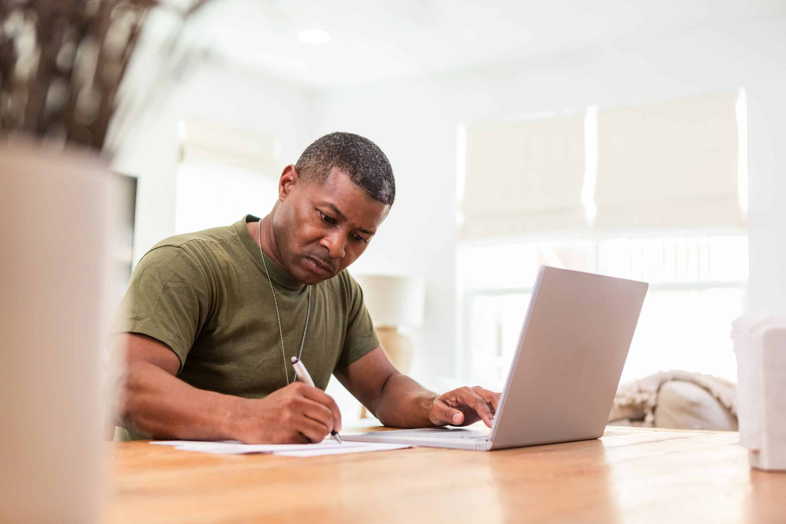 Image of soldier sitting at table writing a SITREP